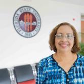 Amarilis Montero standing in front of the FSU Seal