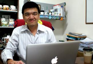 Jose Chong sitting in his office 