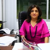 Pushpa Mirchandani sitting in her office