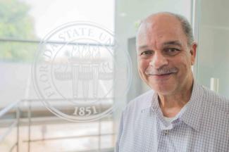 Rafael Pearson in front of FSU Seal